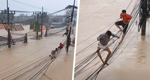 Ужасные кадры из Таиланда: люди спасаются, передвигаясь по проводам во время смертельного наводнения