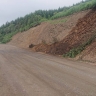 В Томаринском районе расчистили участок дороги, на который сползла сопка